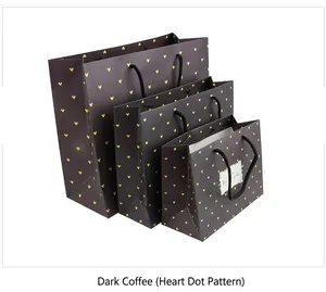 Three-piece set of brown gift bags with yellow heart dots and black handles