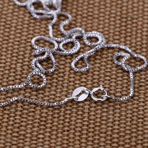 Macro shot of S925 sterling silver box chain necklace with lobster clasp and hallmark
