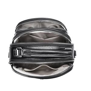 Detailed top view of black leather handbag featuring four zipper compartments and silver hardware