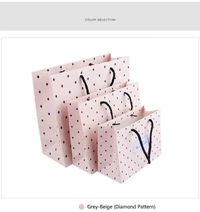 Three minimalist light pink gift bags with diamond heart pattern and black rope handles