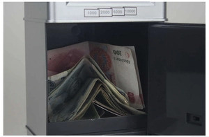 Detail of the smart ATM piggy bank interior showing storage capacity and currency slots