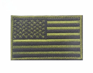 Macro detail of rectangle USA flag tactical patch with green and black embroidery
