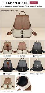 Detail view of contrast color leather backpack with tassel charms and large capacity