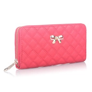 Close-up of pink quilted long wallet with silver bow decoration and zip closure
