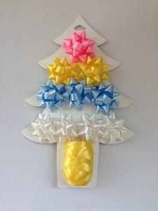 Close-up of colorful 1-inch mini star bows and yellow ribbon on tree-shaped card