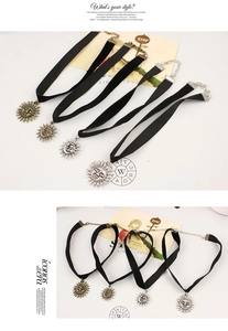 Detail of four velvet chokers with vintage sun and moon face pendants in gold and silver