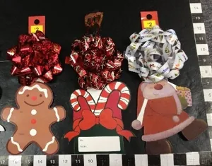 Detailed view of Christmas gift tags with gingerbread man, candy cane, and bear designs