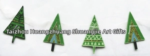 Close-up of green felt Christmas tree banner garden decoration with glitter accents