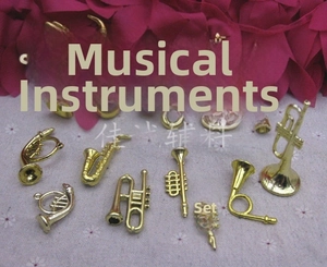 Detailed flat lay of diverse golden musical instrument pendants for DIY crafts