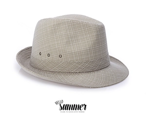 Detail of classic straw fedora featuring breathable metal eyelets and fine weave texture