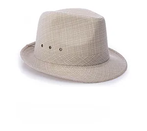 Detail shot of breathable woven texture and metal eyelets on a beige fedora hat