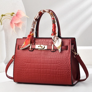 Elegant wine red crocodile pattern tote bag with gold hardware and silk scarf detail