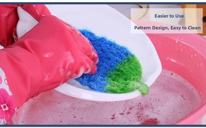 Close-up of double-sided fiber sponge scrub with soapy bubbles for dish cleaning