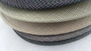 Close-up of various colors and textures of woven brim fabrics on these sun hats