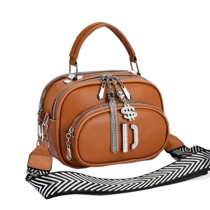 Brown litchi grain shoulder bag with multiple zippers and wide herringbone strap