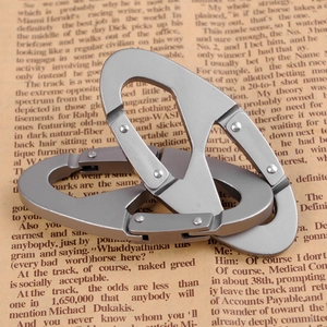 Close-up of silver aluminum alloy survival whistles on vintage newspaper background