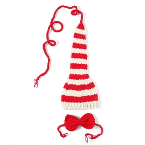 Detail of handmade knit newborn photography set featuring long striped hat and red bow tie