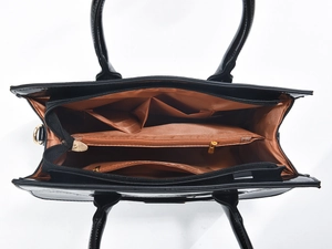 Top view of black faux-crocodile leather bag showing three organized inner compartments