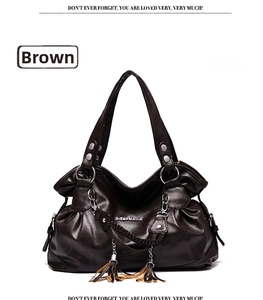 Detail of coffee-colored pebble leather tote bag with fringe tassels and metal chain