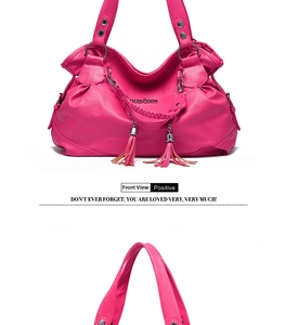 Detail of pink PU leather handbag showing fringe tassel and woven texture handle