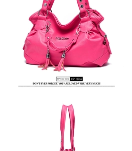 Macro detail of magenta faux leather tote with tassel charms and metallic studs