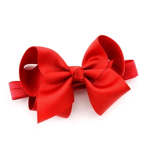 Red grosgrain bow headband for babies and kids with high elastic band on white background