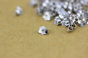 Macro detail of 925 sterling silver earring backs showing authentic 925 hallmarks
