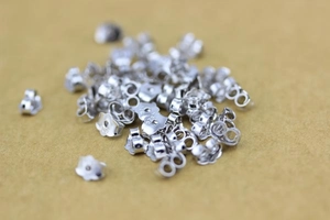 Macro shot of 925 sterling silver butterfly earring backs with hallmarked logo