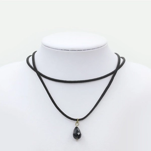 Double-layered black velvet choker necklace featuring a faceted teardrop pendant