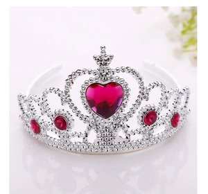 Detail of silver princess crown for girls featuring large red heart-shaped gemstone