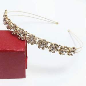 Close-up of golden sunflower headband with sparkling rhinestones on double wire frame