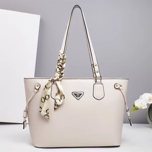 Detail of creamy white tote bag featuring lychee grain texture and silk scarf decoration