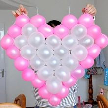 DIY heart-shaped arrangement made with pink and white latex balloons for wedding decor