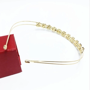 Detail of elegant gold double-layered headband with sparkling sunflower rhinestone motifs