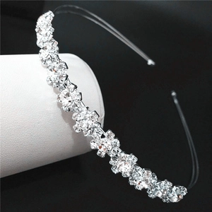 Close-up of sparkling rhinestone sunflower headband with silver metal frame on black background