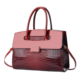 Elegant wine red crocodile pattern handbag with glossy finish and gold buckle