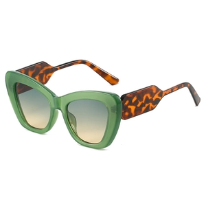 Fashionable oversized cat-eye sunglasses with green frame and tortoiseshell temples