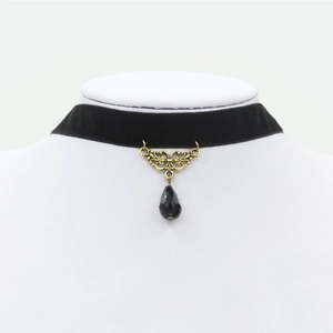 Vintage black velvet choker necklace featuring golden floral charm and black teardrop bead