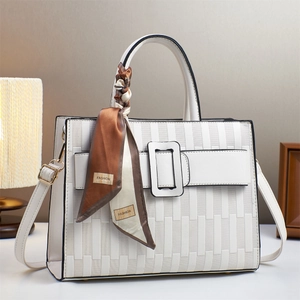 Elegant white tote bag with geometric embossed texture and decorative floral silk scarf