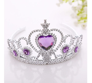 Detailed close-up of a silver princess crown featuring a central purple heart-shaped gemstone