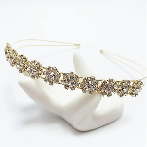 Close-up of golden sunflower headband with sparkling rhinestones on jewelry stand