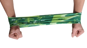 Close-up of green elastic seamless neck gaiter being stretched to show fabric flexibility