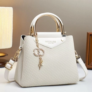 White woven texture handbag with triangle flap and crystal C charm in a lifestyle setting