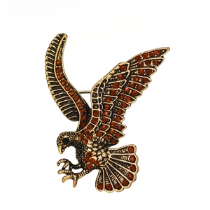 Vintage eagle brooch detailed view, featuring sparkling brown rhinestones set in gold-tone metal.