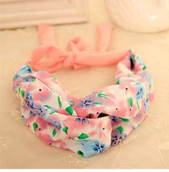 Close-up of a floral knot headband featuring pink and blue patterns with soft ribbons