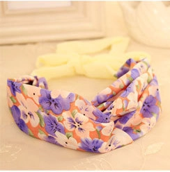 Detail showing twisted floral headband with vibrant purple and orange flower patterns