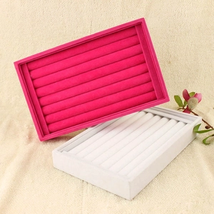Detail view of pink and white ring display trays with velvet slots for jewelry storage