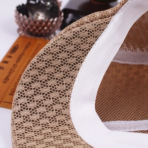 Detailed macro view of khaki breathable mesh fabric and white elastic sweatband