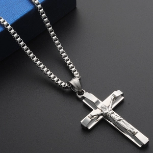 Detail of silver stainless steel box chain necklace with a crucifix cross pendant