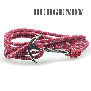 Macro shot of burgundy rope bracelet with silver anchor clasp featuring Vikings engraving